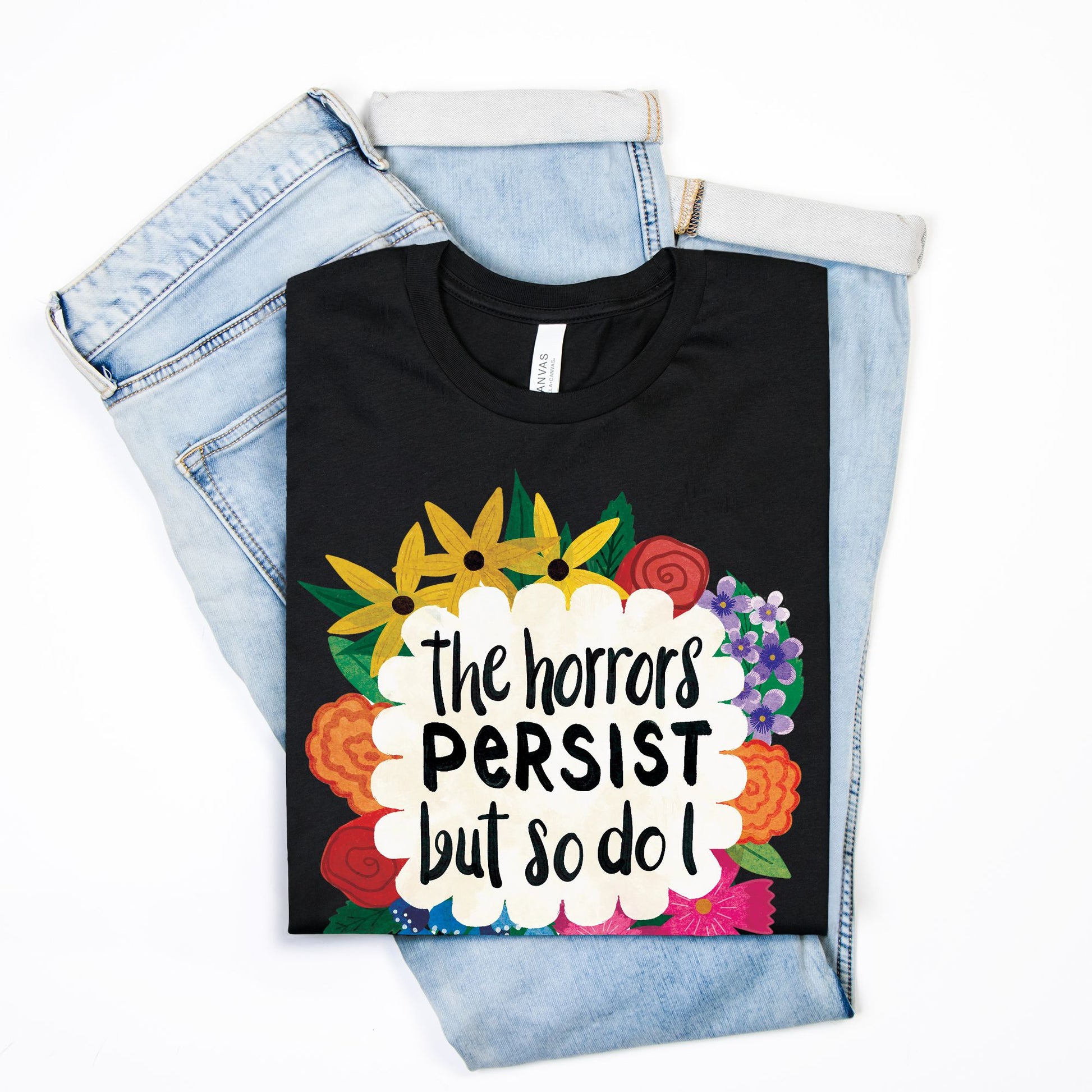 Black t-shirt with colorful floral design and text on a white background