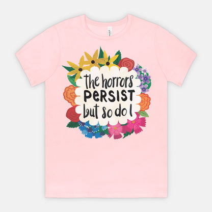 Pink t-shirt with floral design and text on a light gray background